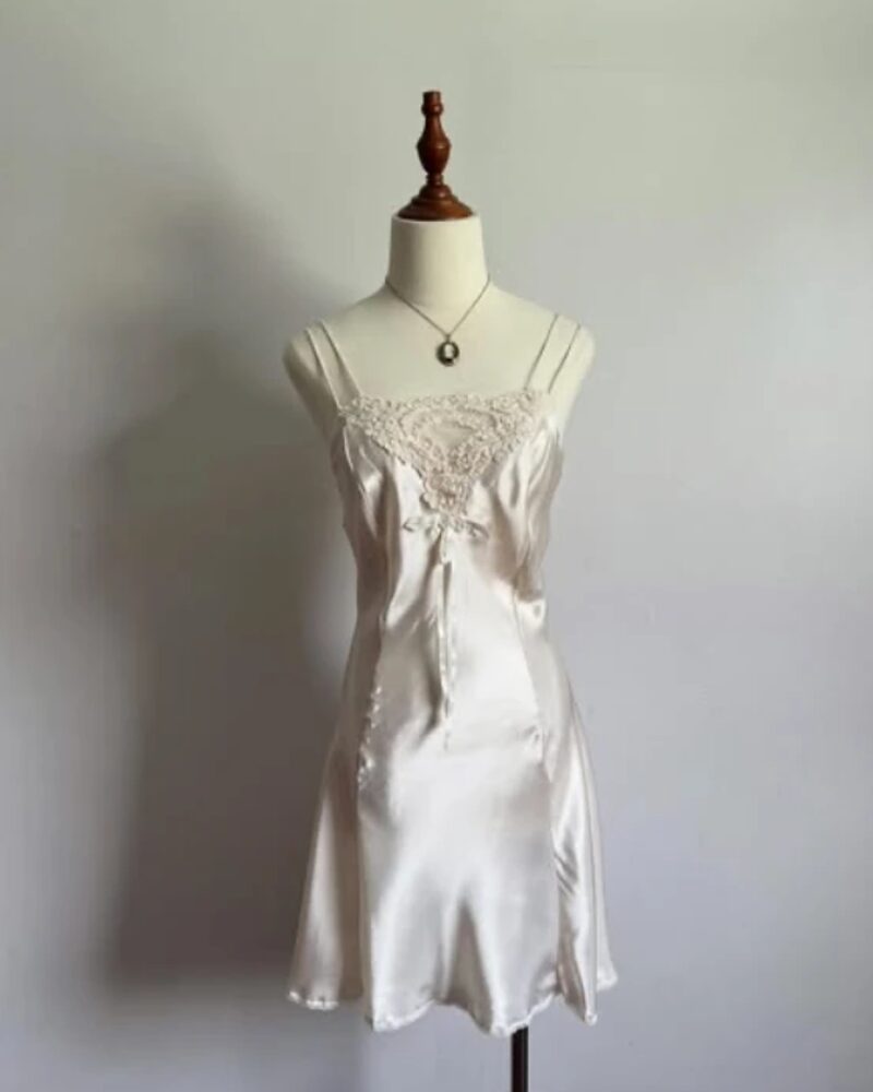 Ivory silk satin short slip with a lace bust, on a dress form