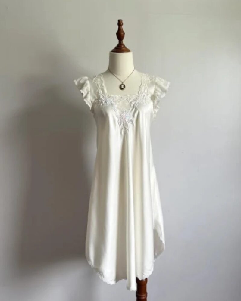 Ivory satin nightgown with flutter sleeves and embroidered lace, on a dress form